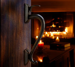 door open to room with burning hearth image